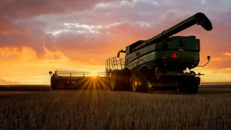 John Deere combine against a horizon.