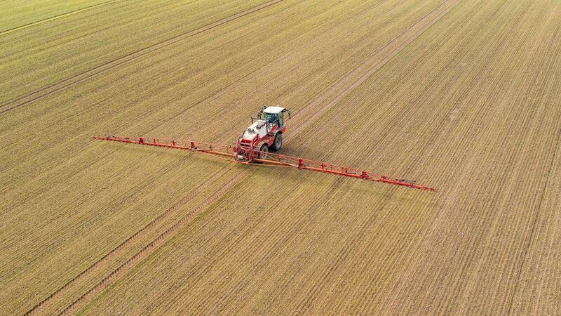 A tractor spraying a field
