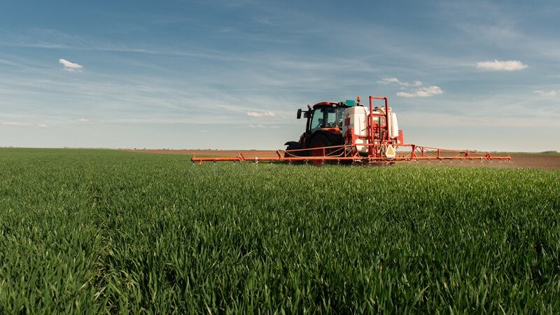 A tractor spraying herbicide
