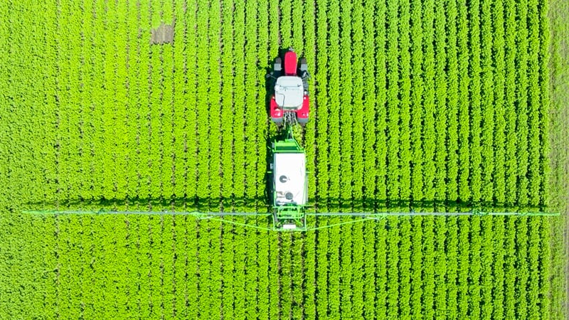 A tractor spraying a field