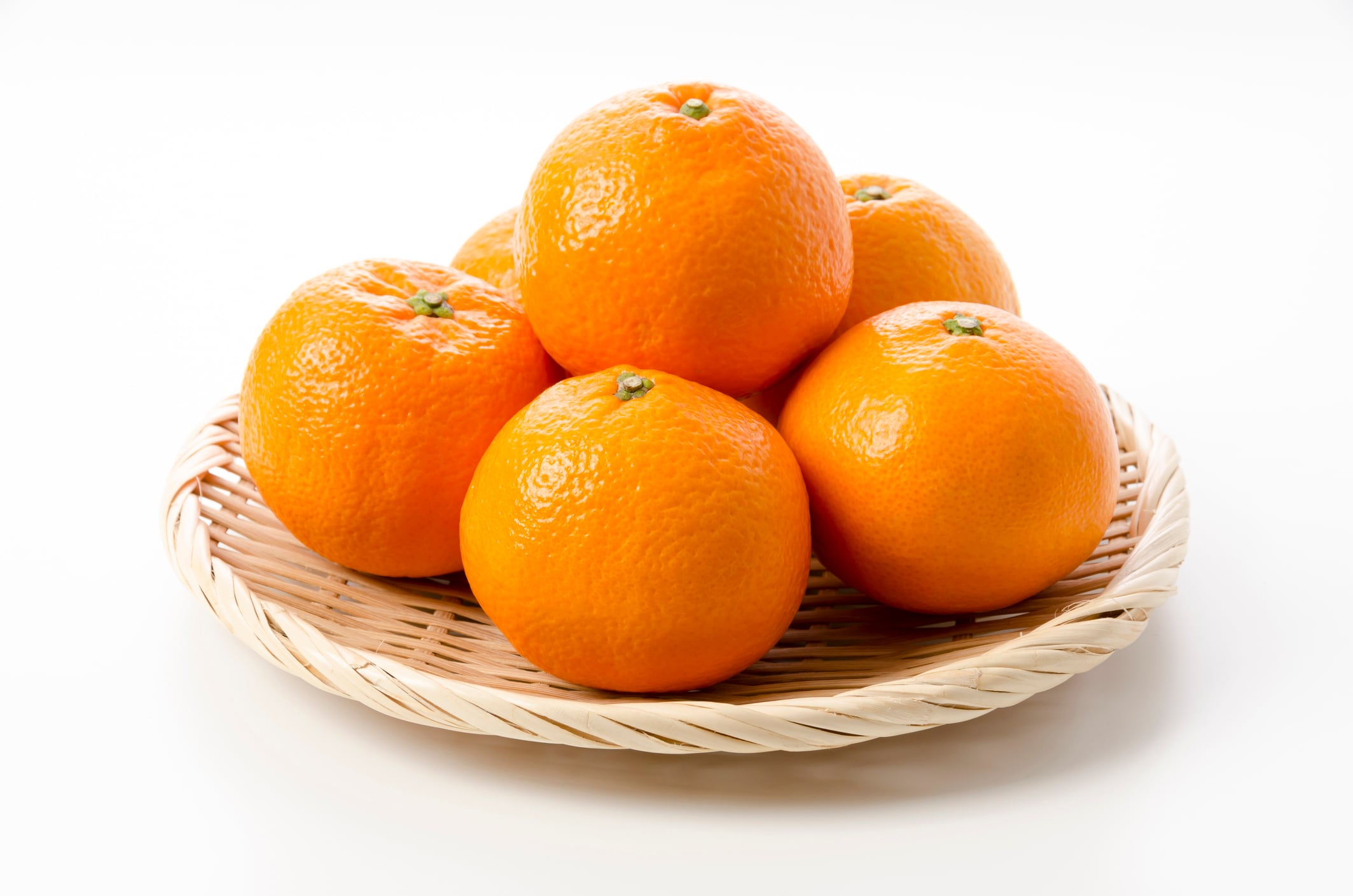 fresh Citrus iyo on bamboo colander on white background, Japanese citrus fruits called Iyokan