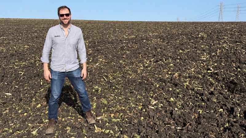 Charles Smith, CEO and founder of IMIO, standing in a brussels sprouts field.